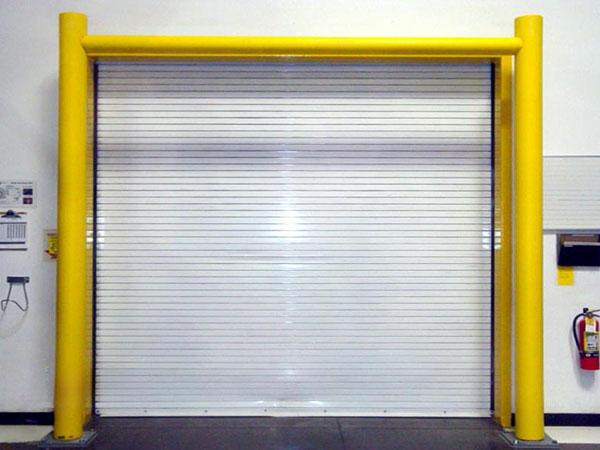 Yellow goal post style guardrail in front of white dock door